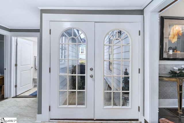 interior space with ornamental molding and french doors