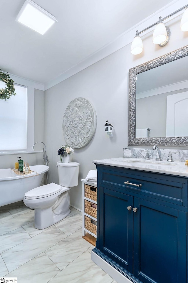 full bath with toilet, ornamental molding, a soaking tub, and vanity