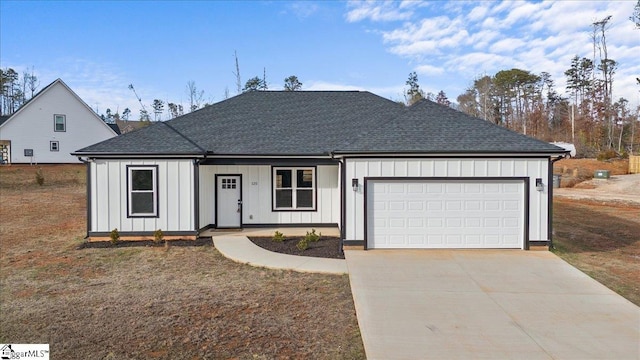 view of front of property with board and batten siding, concrete driveway, and a garage