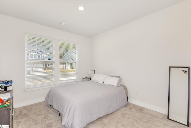 bedroom featuring recessed lighting, visible vents, baseboards, and light colored carpet