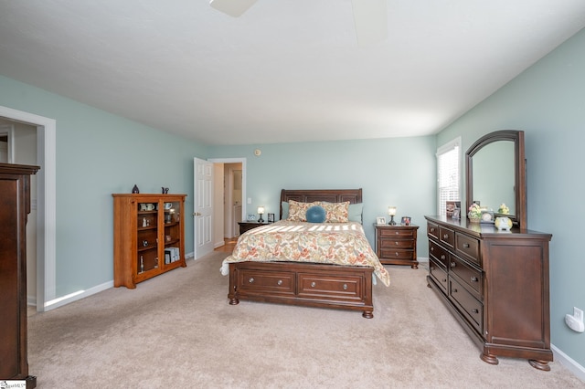 bedroom with baseboards and light colored carpet