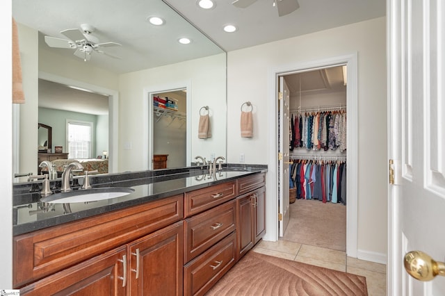 bathroom featuring tile patterned floors, double vanity, a sink, and ceiling fan