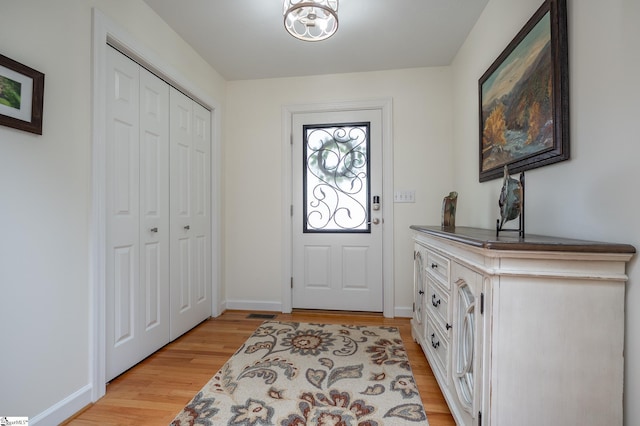 entrance foyer with light wood-style floors and baseboards