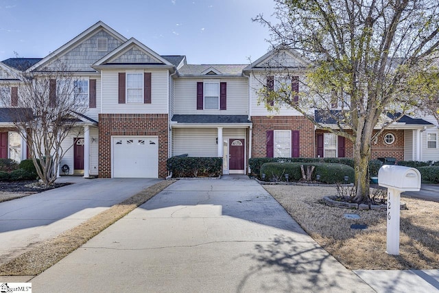 townhome / multi-family property featuring concrete driveway, brick siding, and an attached garage