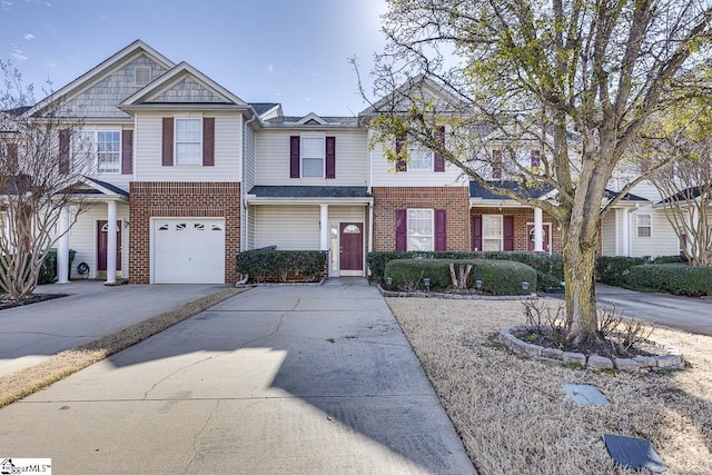 view of front of home with driveway, a garage, and brick siding