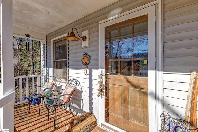 entrance to property featuring a porch