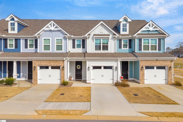 multi unit property with board and batten siding, brick siding, and driveway