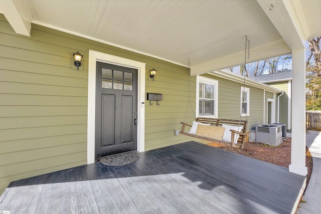 entrance to property featuring central AC unit and a porch