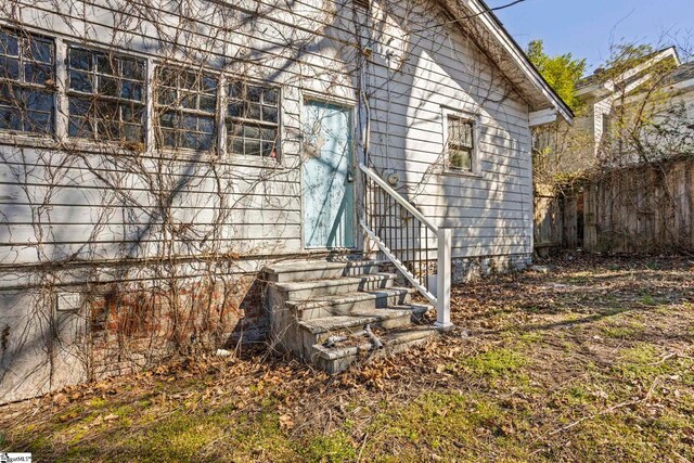 view of exterior entry with fence