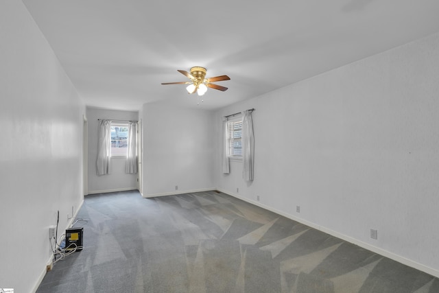 empty room featuring carpet, baseboards, and ceiling fan