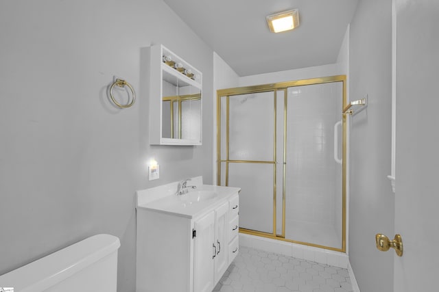 bathroom featuring a stall shower, vanity, toilet, and tile patterned floors