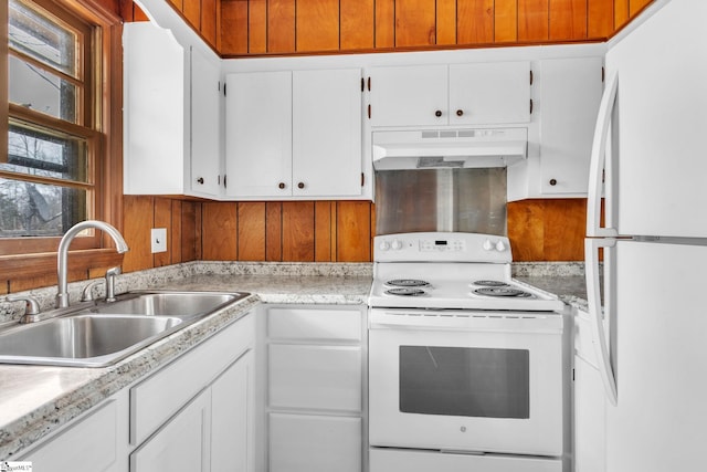 kitchen featuring light countertops, white appliances, a sink, and under cabinet range hood