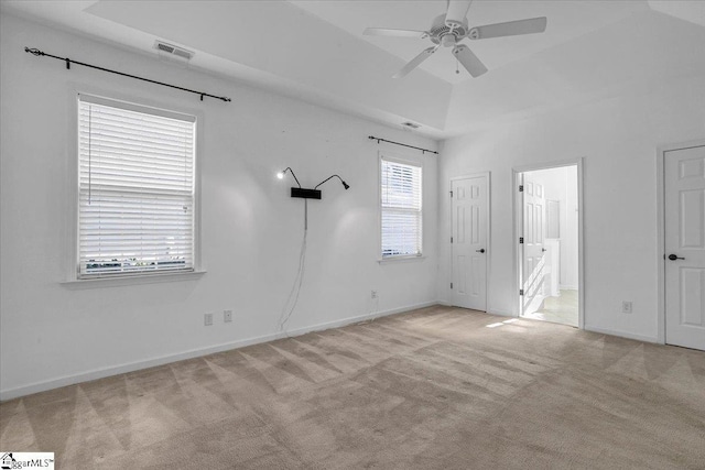 unfurnished room featuring a ceiling fan, light carpet, visible vents, and baseboards