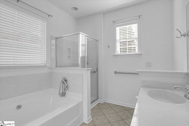 full bath with a garden tub, a sink, a shower stall, baseboards, and tile patterned floors