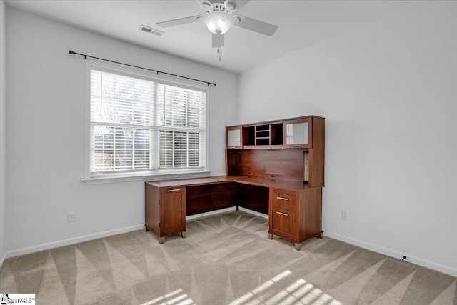 unfurnished office with baseboards, visible vents, and light colored carpet