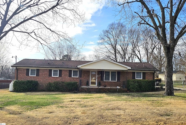 ranch-style house featuring brick siding and a front lawn