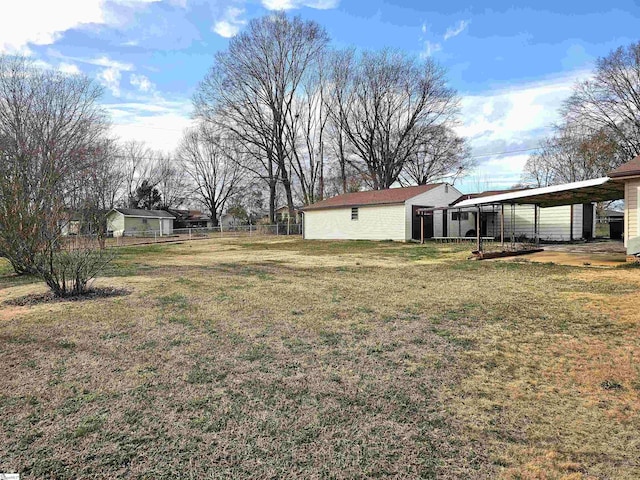 view of yard featuring a carport and fence