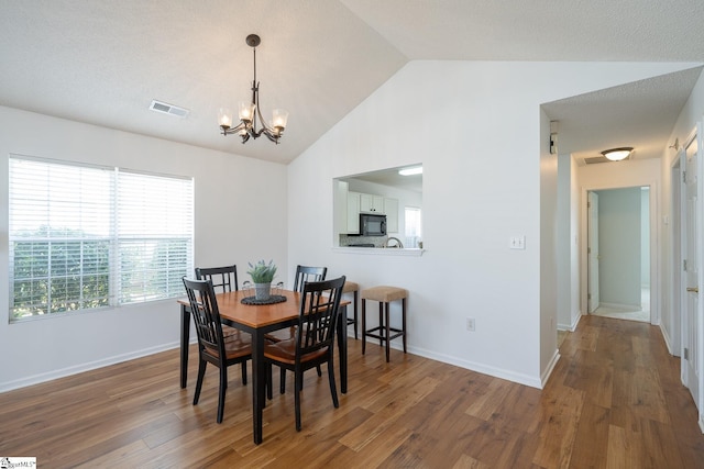 dining space featuring lofted ceiling, baseboards, visible vents, and dark wood-style flooring