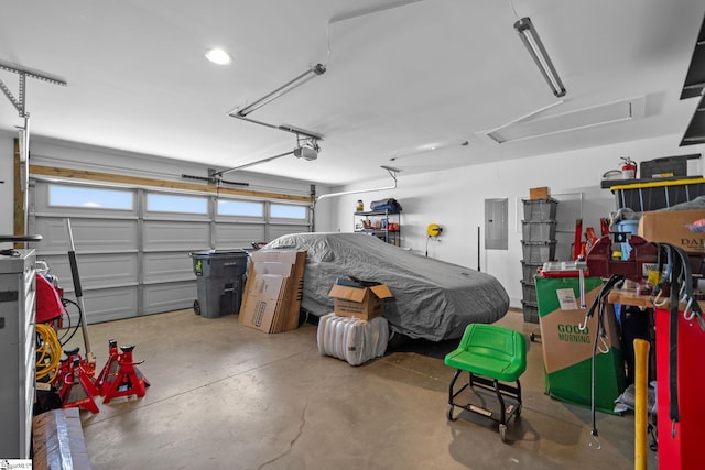 garage featuring electric panel and a garage door opener