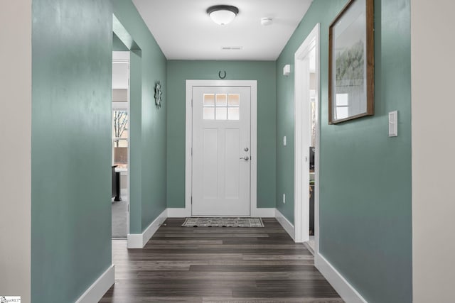 entryway with baseboards and dark wood-style flooring