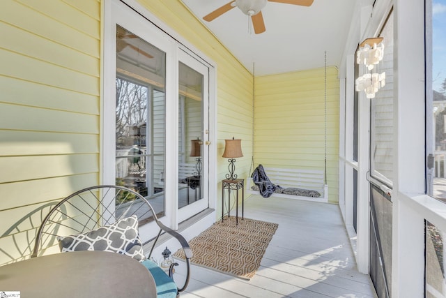 sunroom / solarium with a ceiling fan