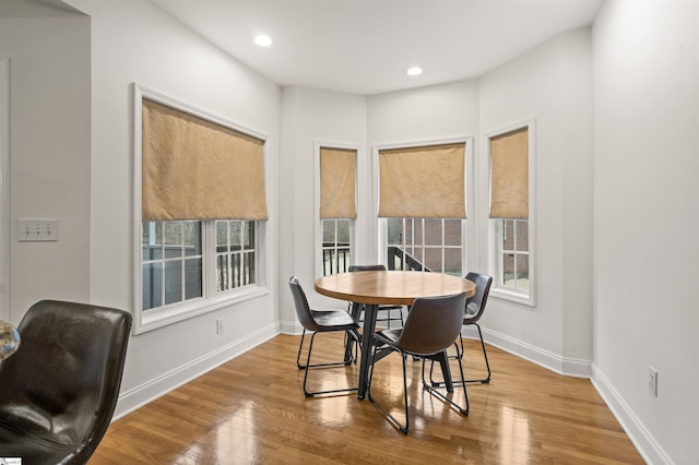 dining space featuring recessed lighting, baseboards, and wood finished floors