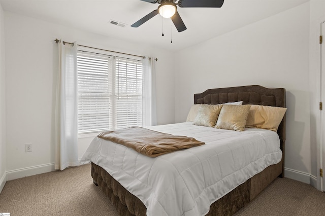 bedroom featuring light carpet, a ceiling fan, visible vents, and baseboards