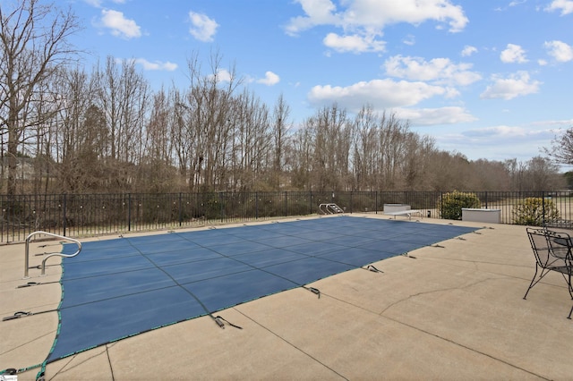 view of swimming pool featuring a fenced in pool, a patio, and fence