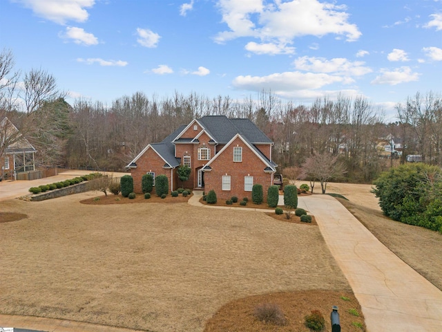 view of front facade featuring concrete driveway and brick siding