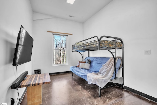 bedroom with finished concrete flooring, visible vents, baseboards, and vaulted ceiling