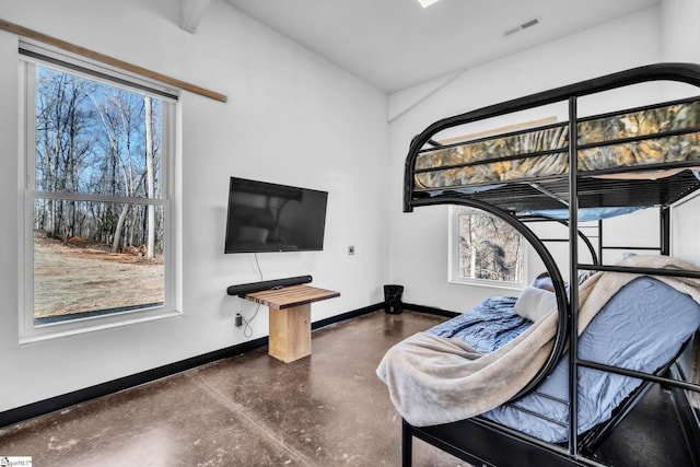 bedroom featuring finished concrete flooring, baseboards, multiple windows, and visible vents