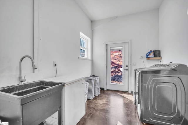 laundry room featuring laundry area, a sink, and washing machine and clothes dryer