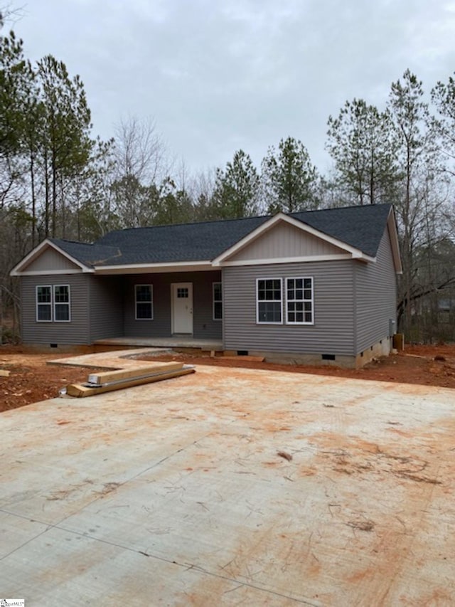 single story home with crawl space, concrete driveway, and roof with shingles