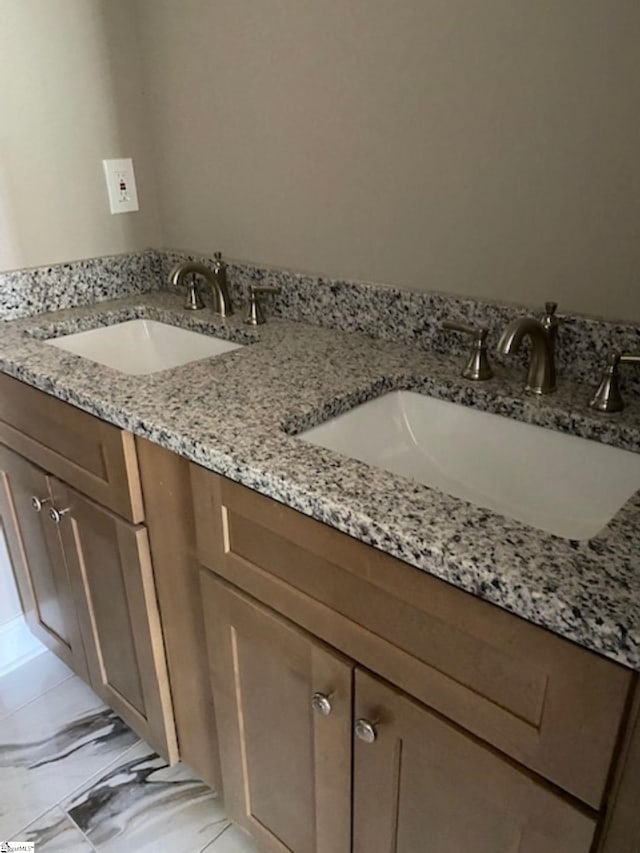 bathroom featuring double vanity and a sink