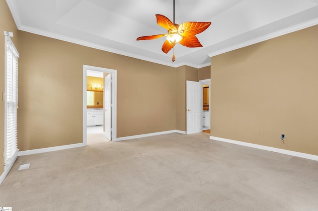 unfurnished bedroom with baseboards, a raised ceiling, and ornamental molding