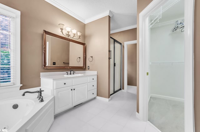 bathroom featuring a spacious closet, ornamental molding, plenty of natural light, and vanity