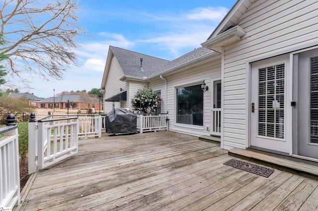 wooden deck featuring a grill