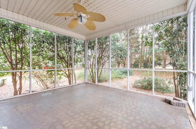 unfurnished sunroom featuring a ceiling fan