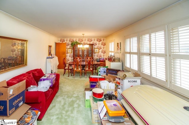 carpeted living area with a chandelier and ornamental molding