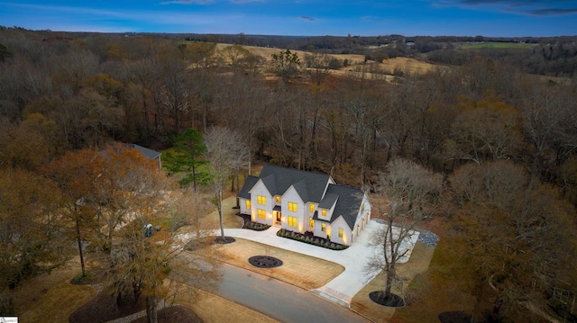 bird's eye view featuring a wooded view