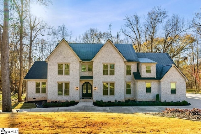 view of front of property with a front yard, crawl space, and brick siding