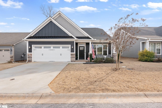 craftsman-style home featuring a porch, concrete driveway, an attached garage, board and batten siding, and a standing seam roof