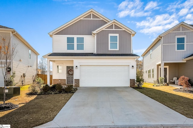 craftsman house with a garage, brick siding, concrete driveway, board and batten siding, and a front yard