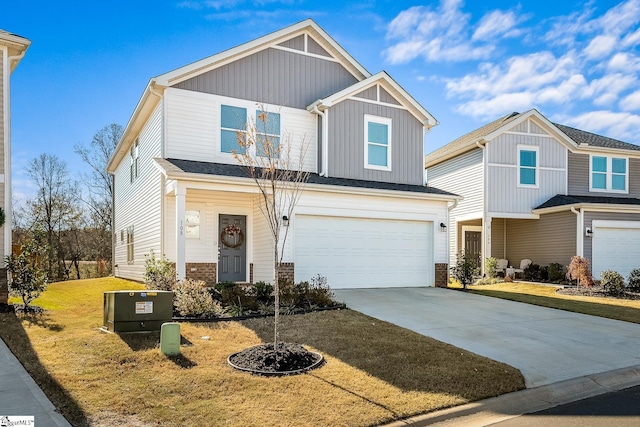 craftsman inspired home with a garage, a front lawn, and concrete driveway