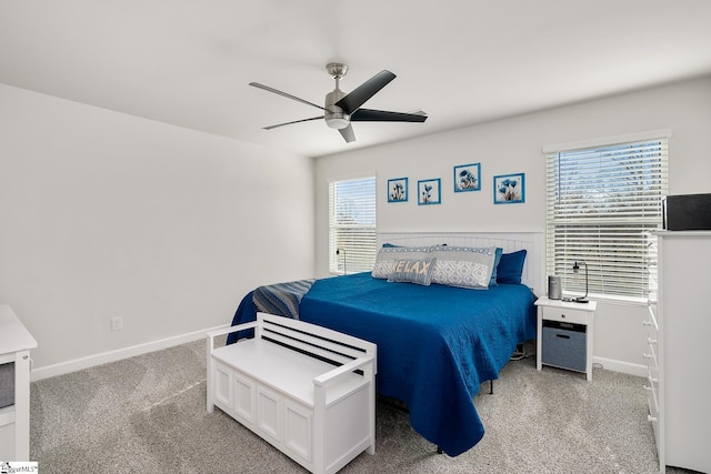 bedroom with a ceiling fan, carpet, and baseboards