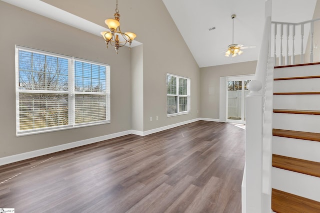 interior space featuring visible vents, baseboards, wood finished floors, stairs, and high vaulted ceiling