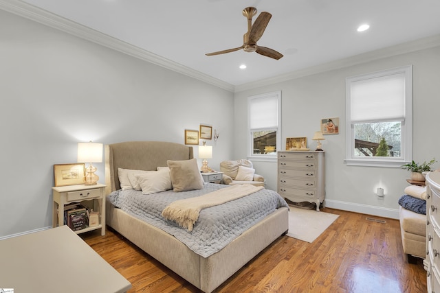 bedroom with recessed lighting, wood finished floors, visible vents, baseboards, and ornamental molding