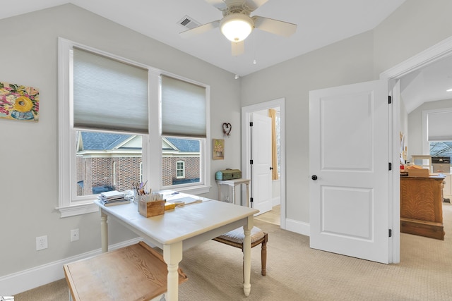 dining room featuring light carpet, ceiling fan, visible vents, and baseboards