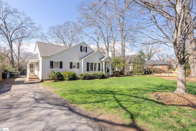 view of front facade with a front lawn and aphalt driveway