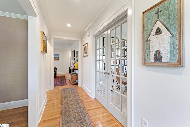 hallway with french doors, wood finished floors, and crown molding